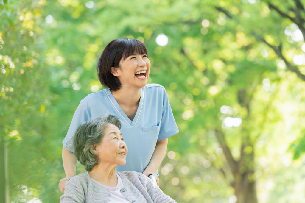 senior woman in wheelchair and female health care worker.